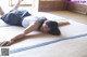 A woman laying on a tatami mat in a room.